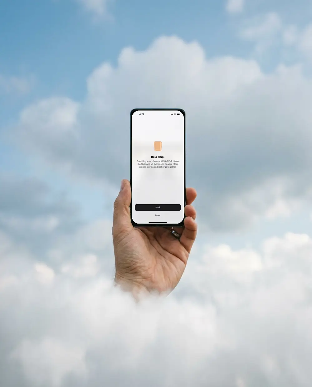 A hand holds an iPhone up out of the clouds. At 4:21 the screen shows an idea: Be a ship.
